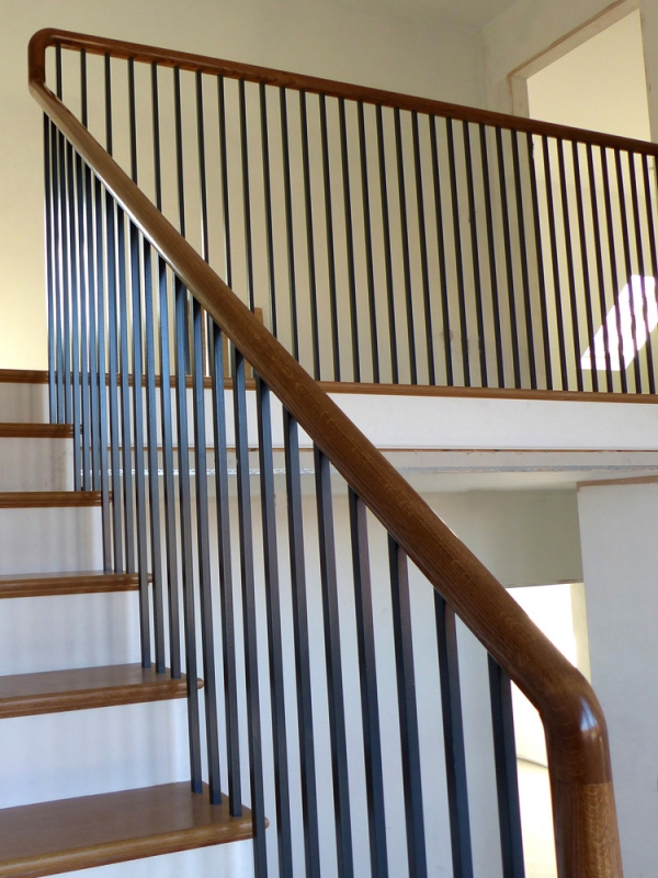 Continuous Handrail Staircase leading to Gallery with Black Powder Coated Balustrade